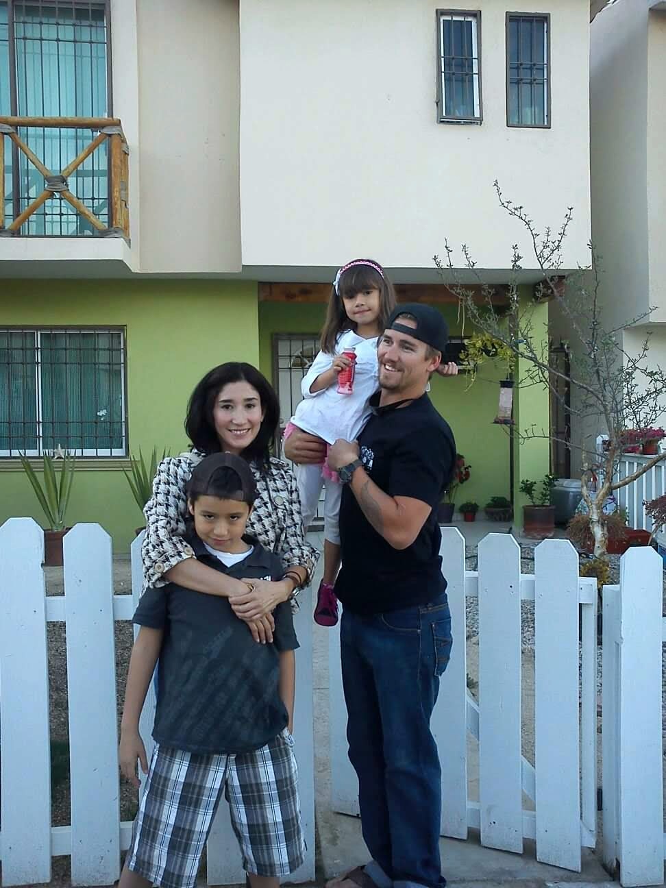 The four of us together outside our home
