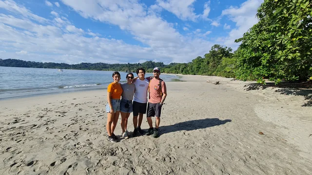 Four family members together on a sunny beach